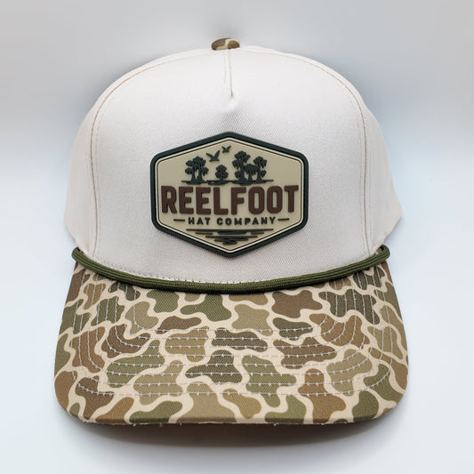 Front view of Reelfoot Cypress Flight cream canvas rope cap with duck-camo bill and silicone logo patch